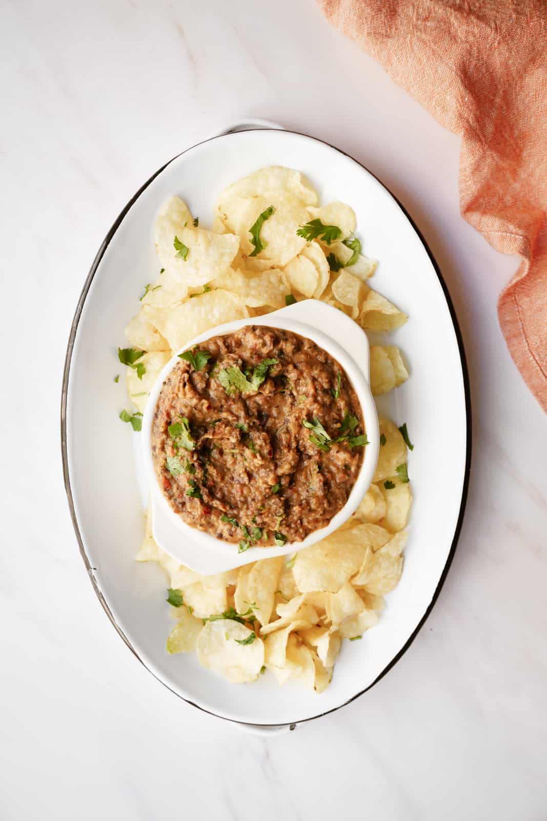 Black bean dip recipe on serving dish with potato chips