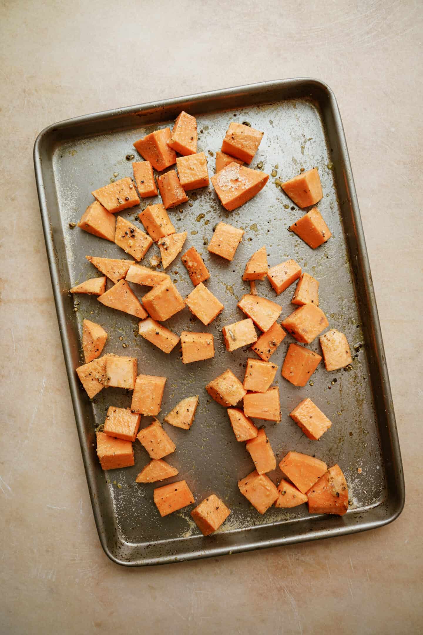 Sweet potatoes spread on a baking sheet