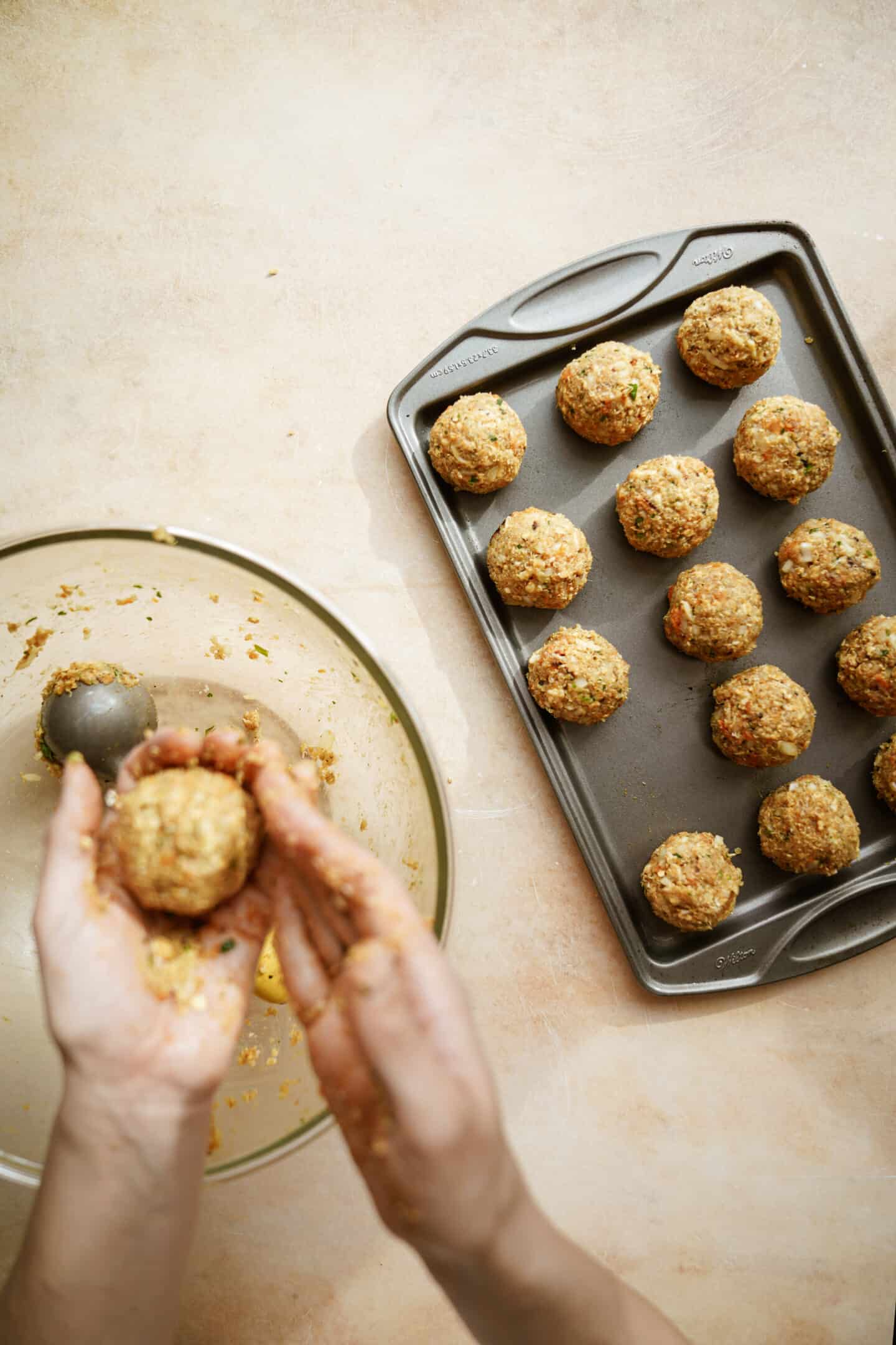 Hand rolling sweet potato balls with quinoa