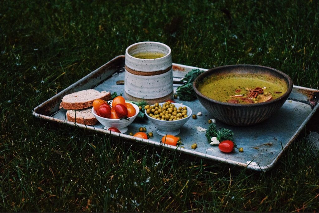 Cauliflower Kale Soup on a tray in the grass