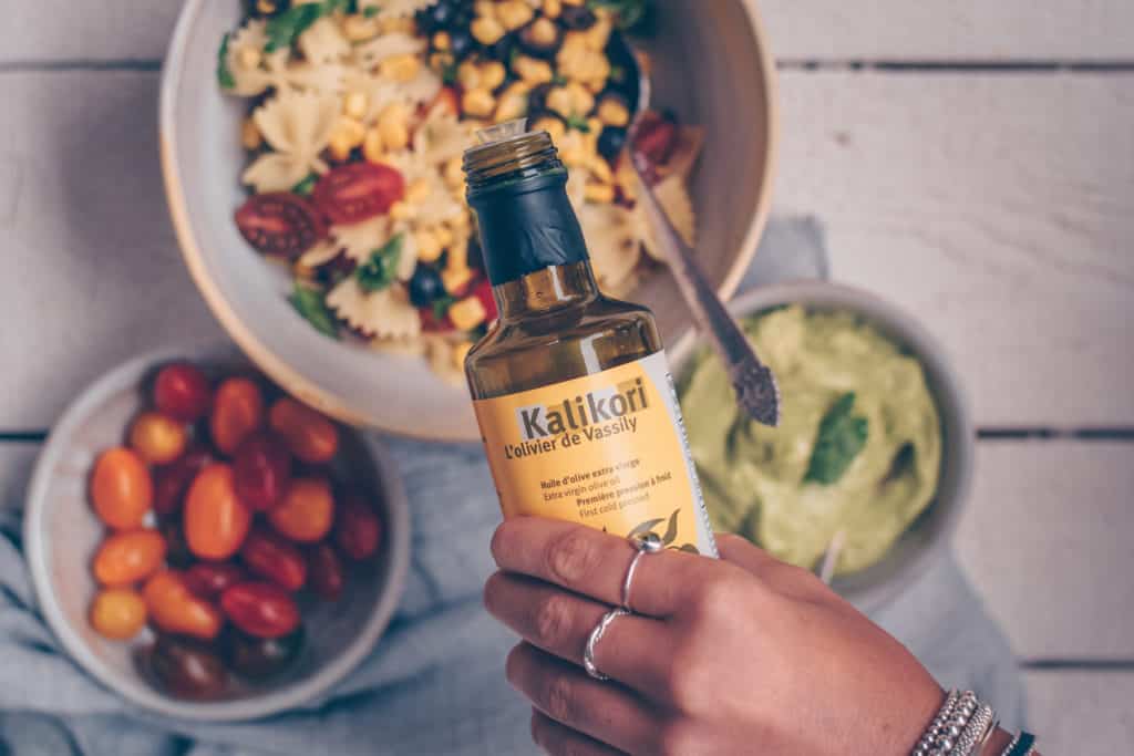 Olive oil being poured into Bowtie Pasta Salad