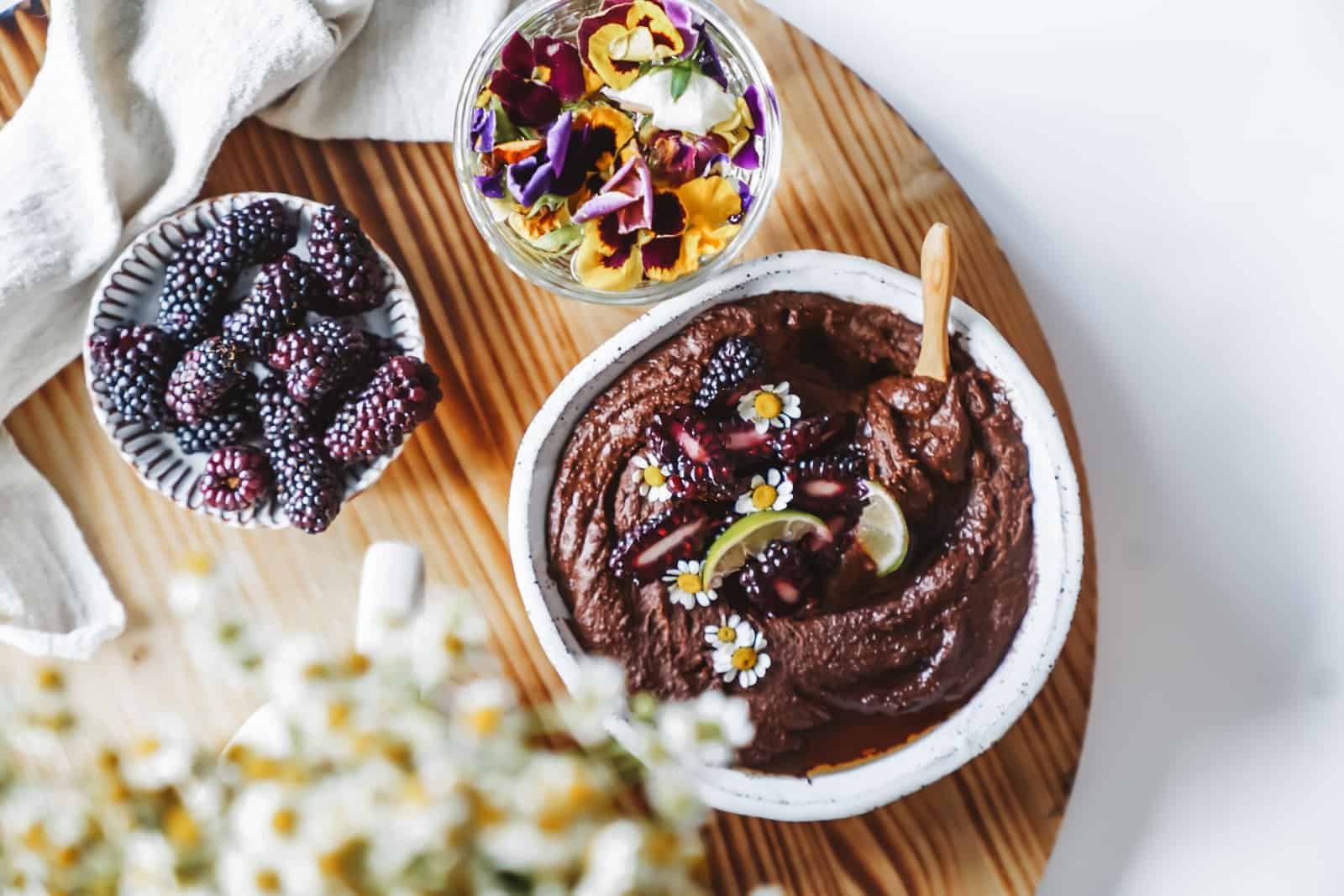 Chickpea Dessert chocolate sauce on a board with fresh fruit and flowers