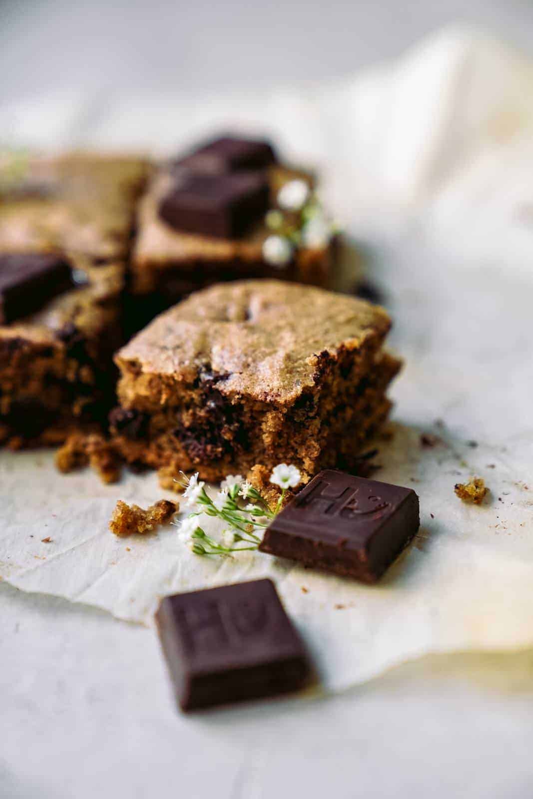 Close-up of slice of vegan blondies with slices of chocolate.