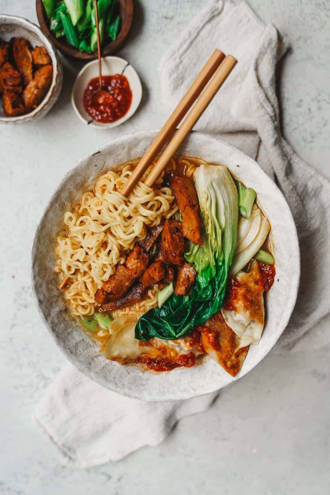 Bowl of creamy vegan ramen with chopsticks