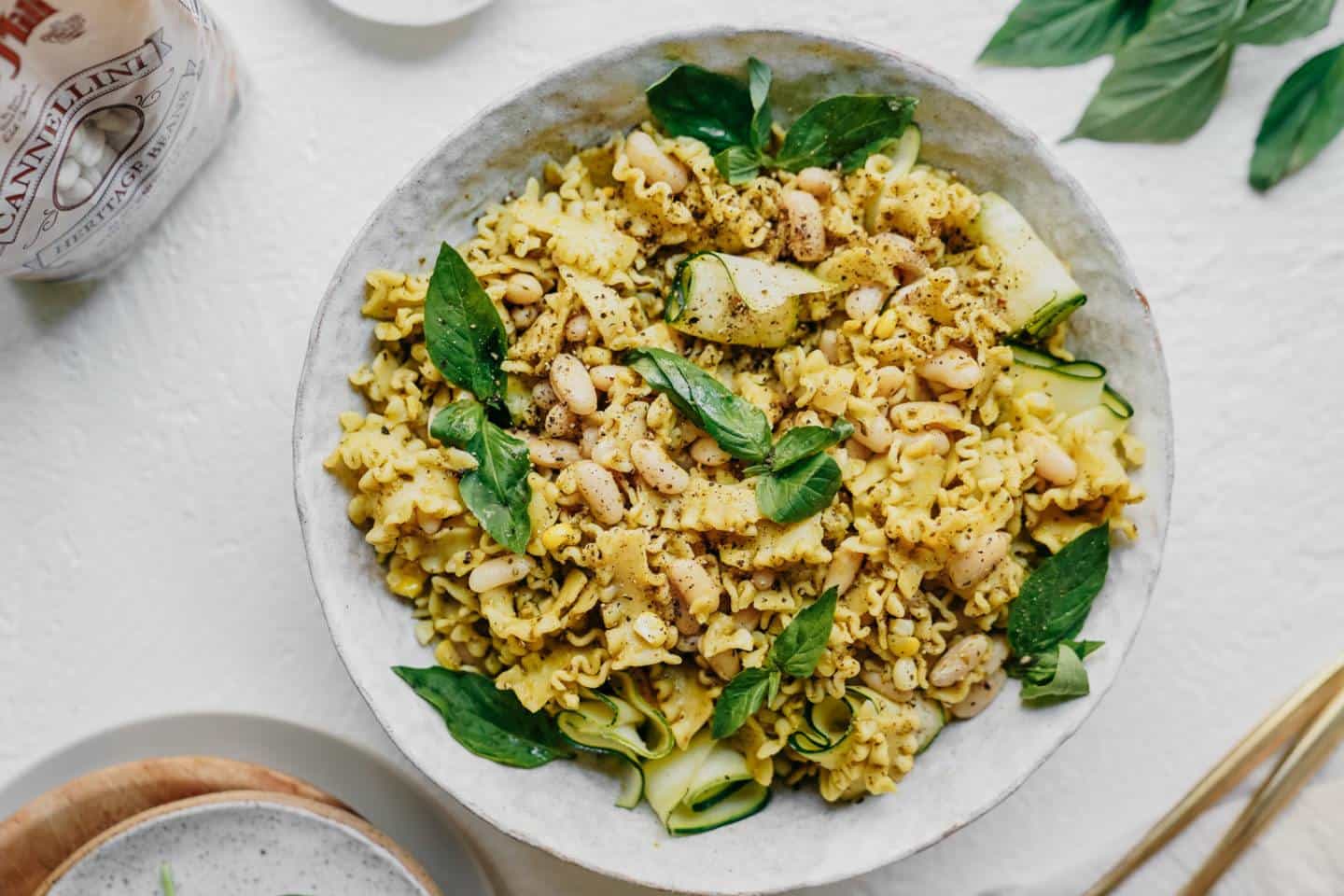 Summer vegan pesto pasta in a white bowl 