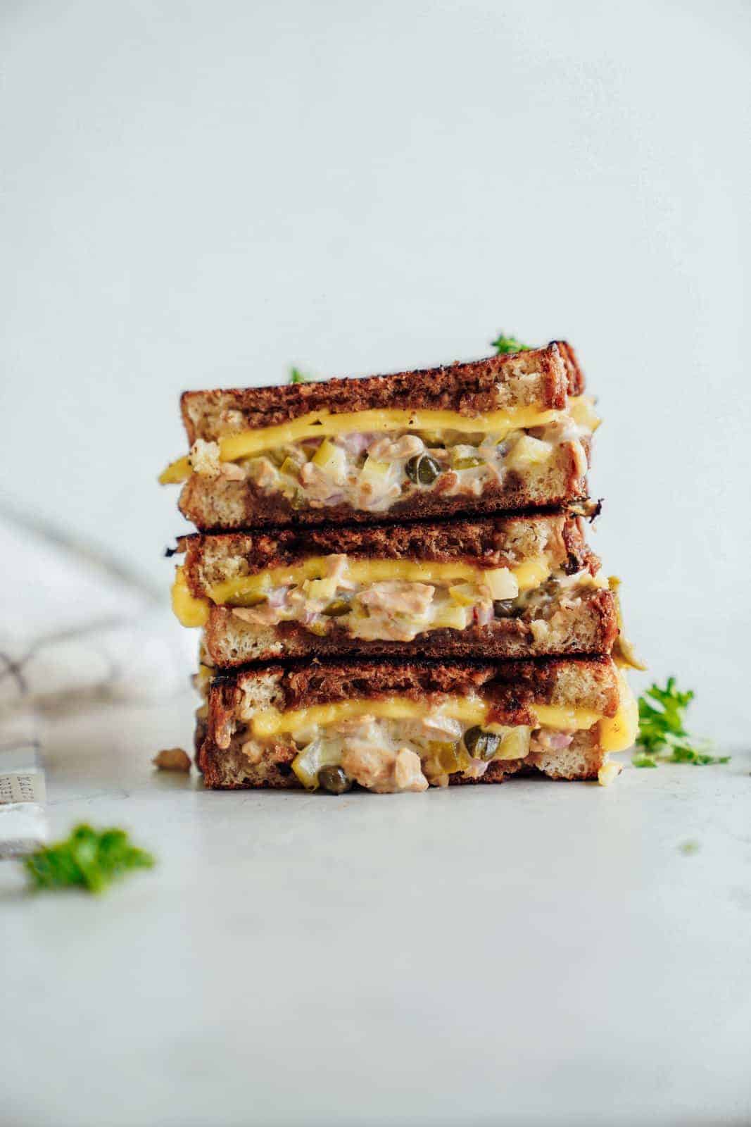 A stack of cheesy vegan tuna melt on countertop.