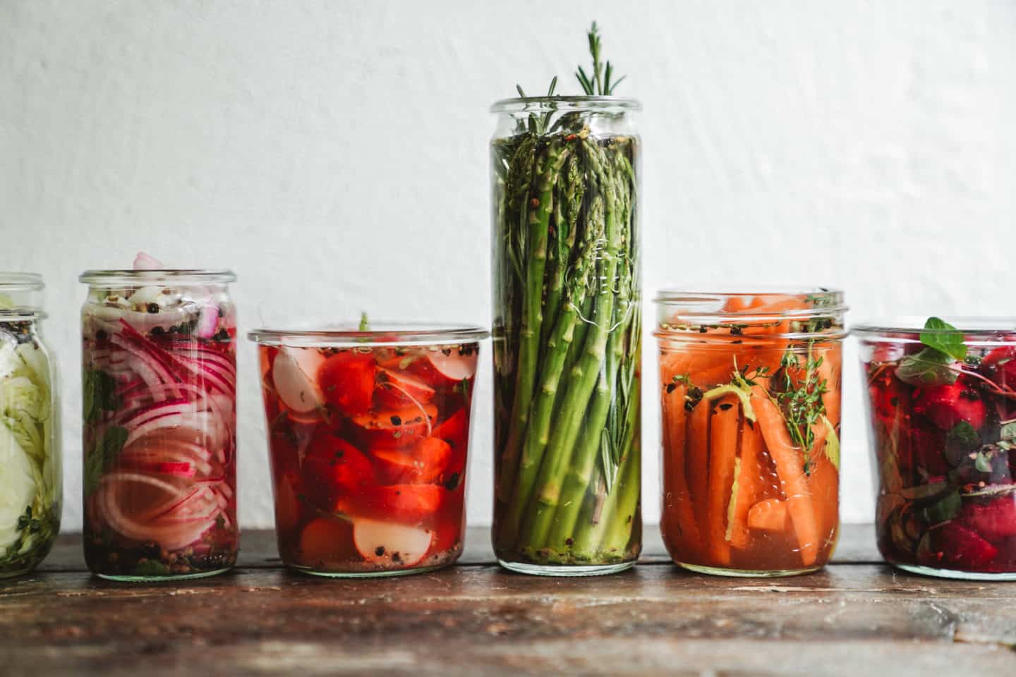 Pickled veggies lined up on wood countertop. A great recipe to make this September.