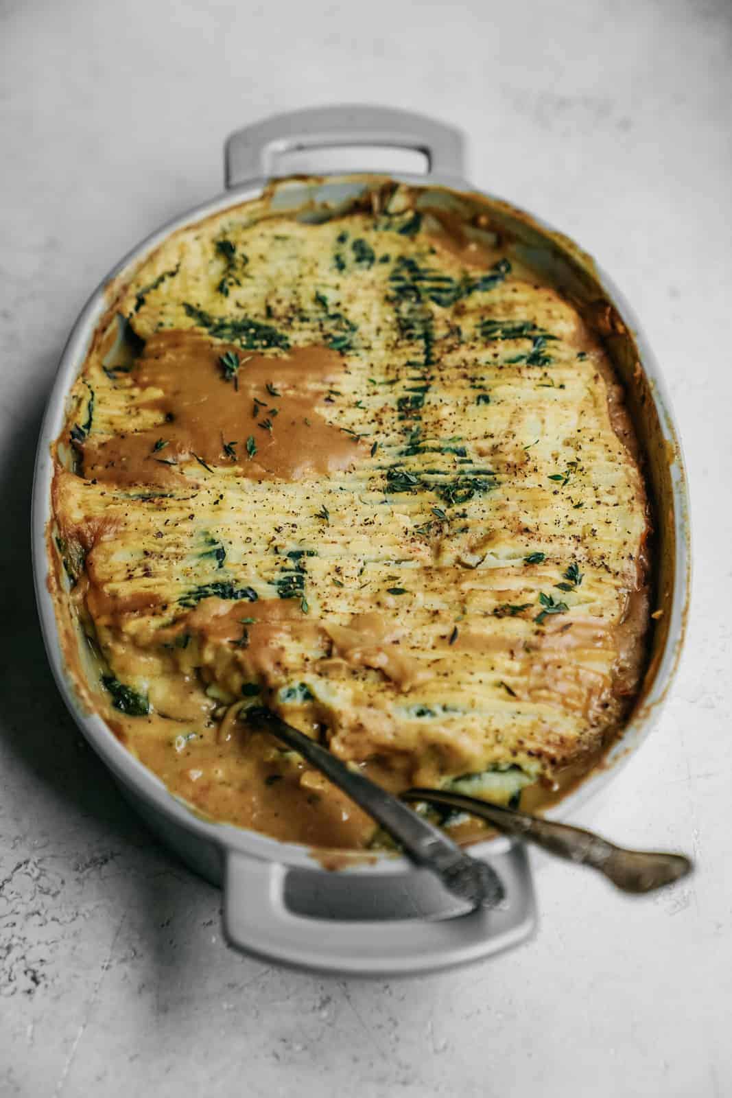 Yummy baked mashed potatoes in a serving dish with a crisp top ready to be served.