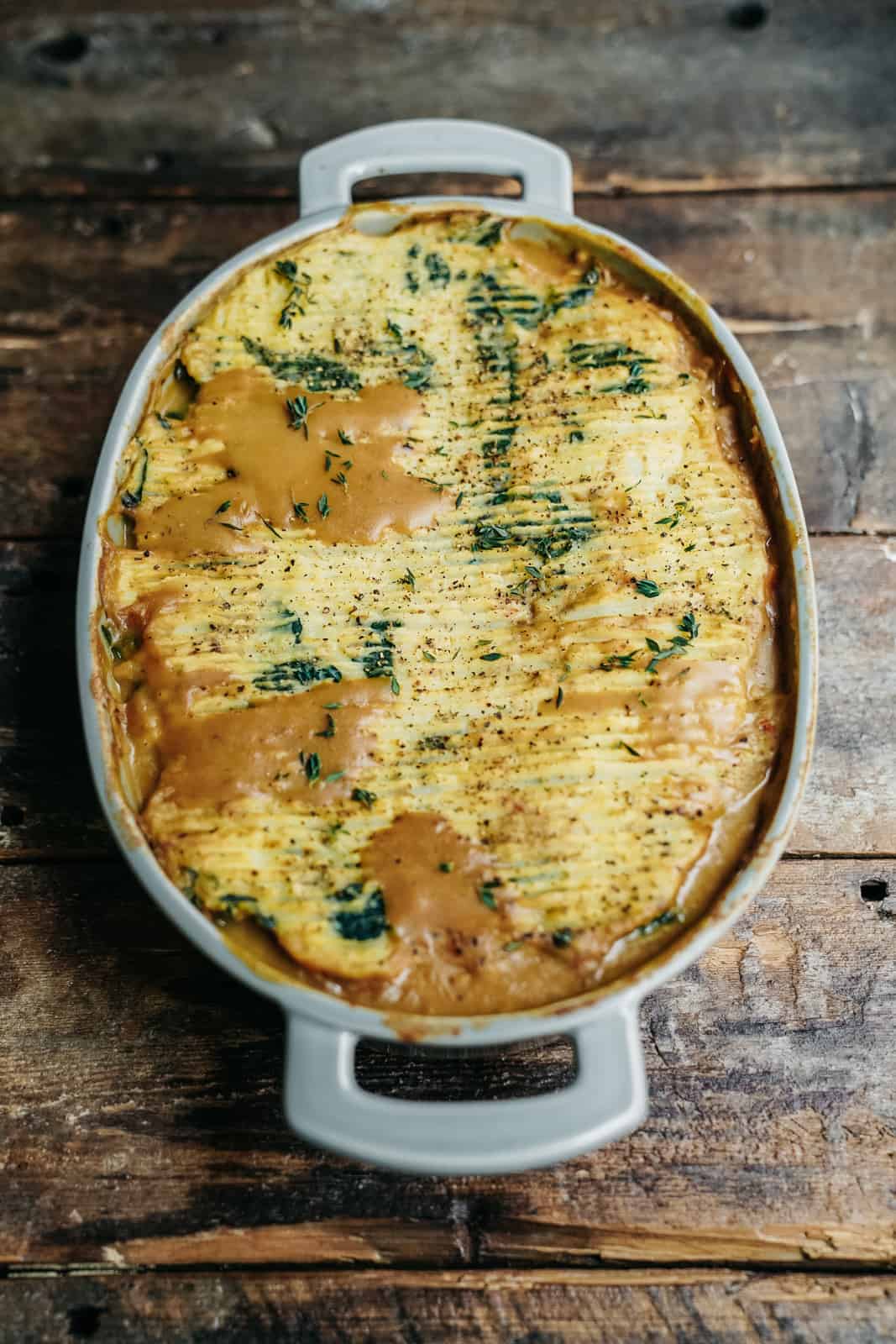 Vegan mashed potatoes and gravy with caramelized onions and a crunchy crust from being baked in the oven