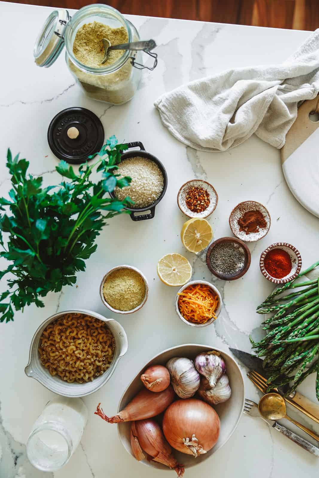 Fresh ingredients for vegan casserole with plant-based tuna spread across countertop.