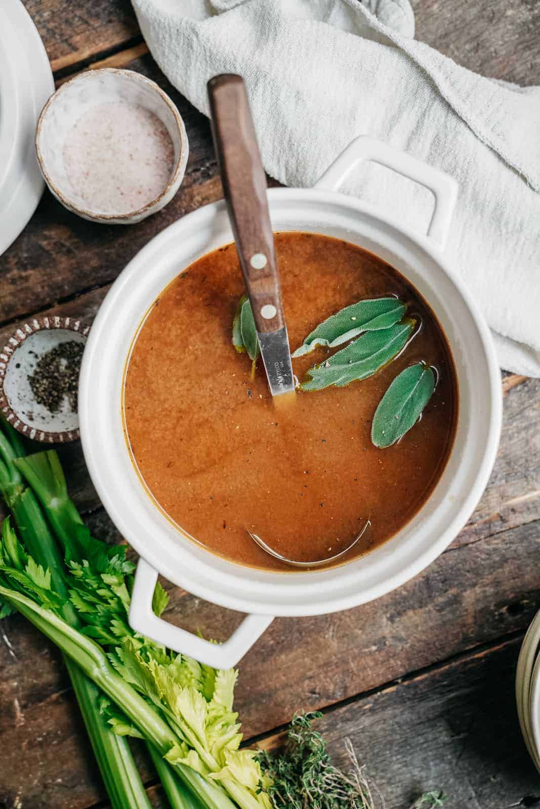 Bowl of homemade vegetable stock recipe on countertop.