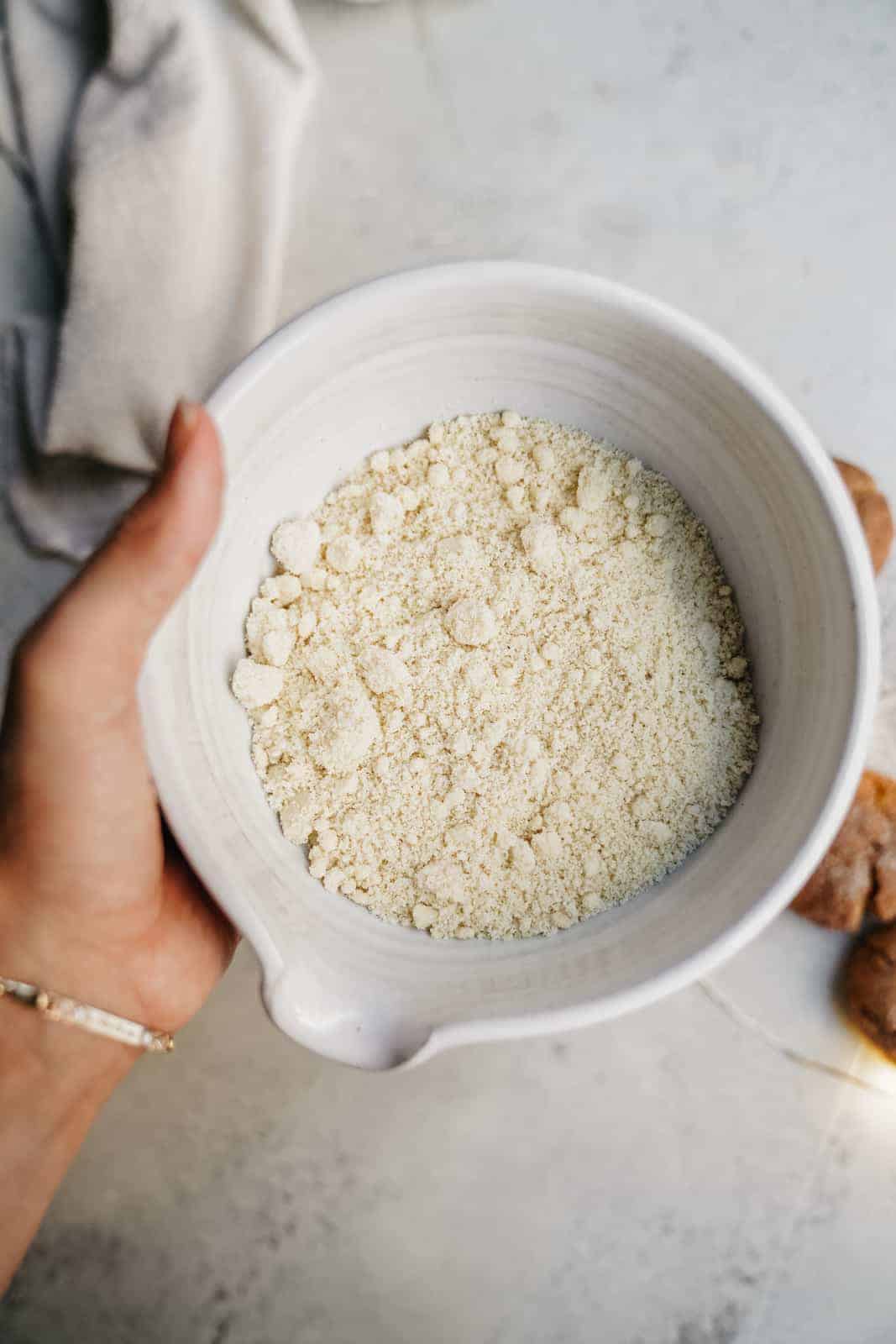 Bowl of almond flour ready to pour into Vegan Sugar Cookie Recipe.