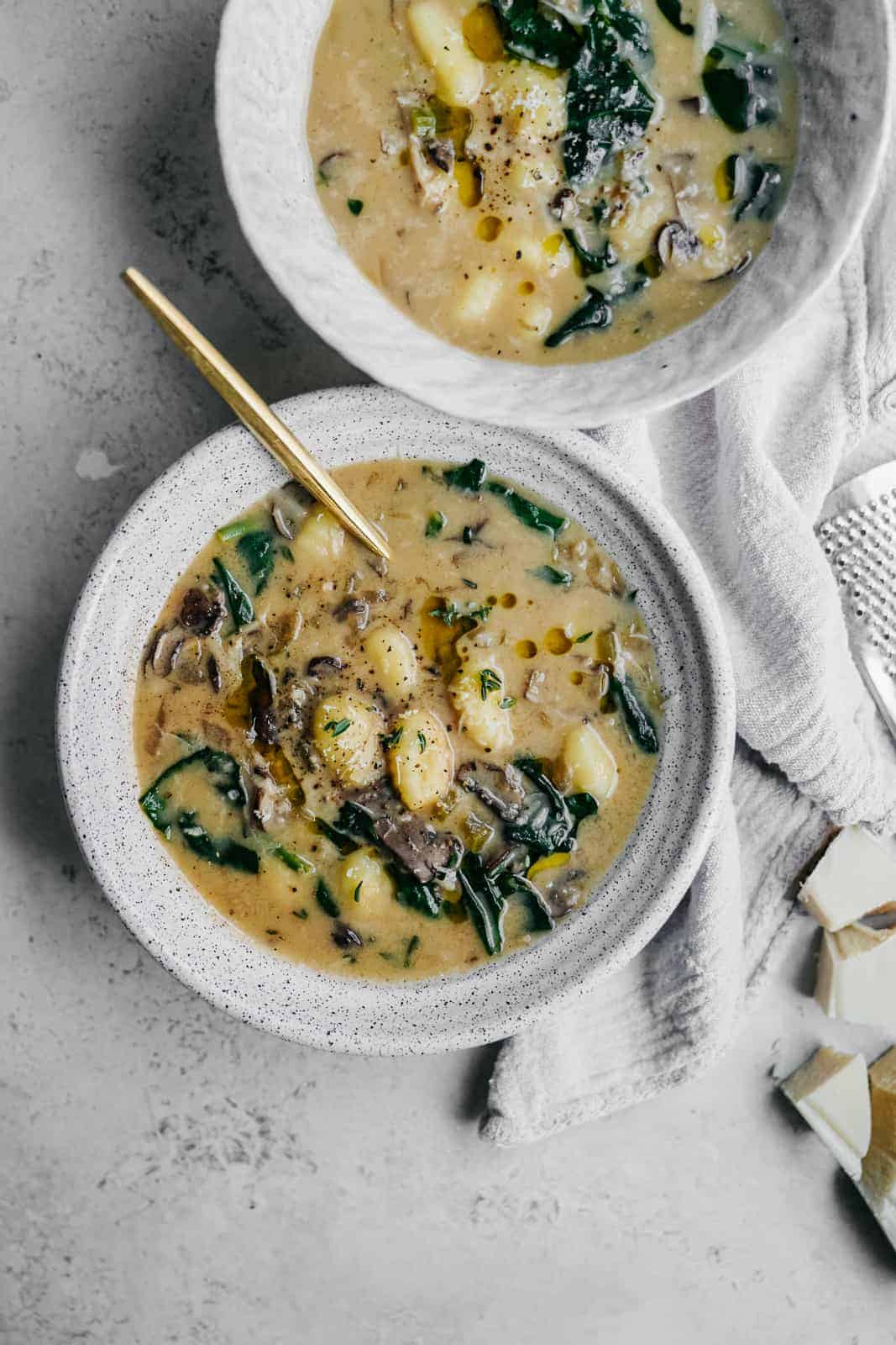 Spinach & Gnocchi Soup in a bowl with a spoon. A great soup idea for using gnocchi.