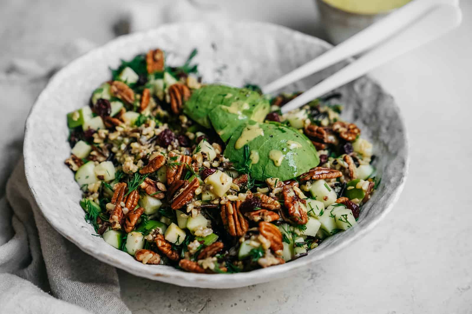 A side angle shot of a salad bowl with a grainy, flavorful salad.