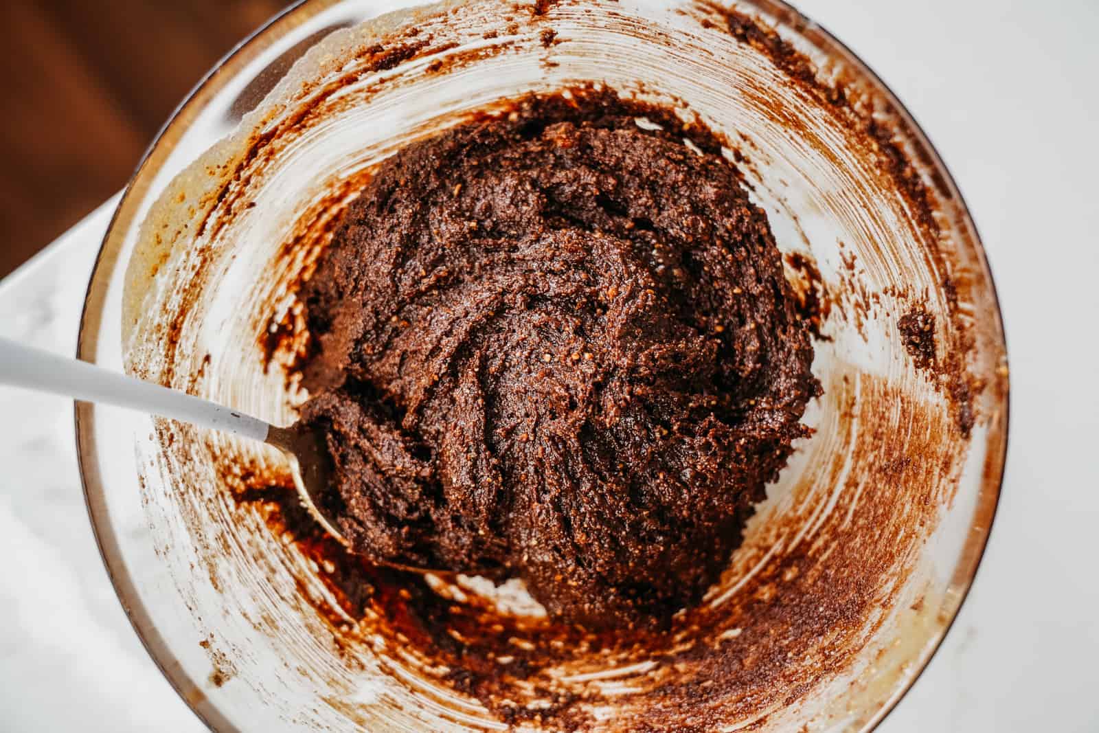 All ingredients for Almond Flour Brownies sitting in glass bowl all mixed up.