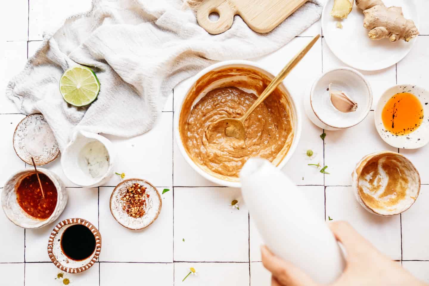 Person demonstrating how to make peanut sauce 