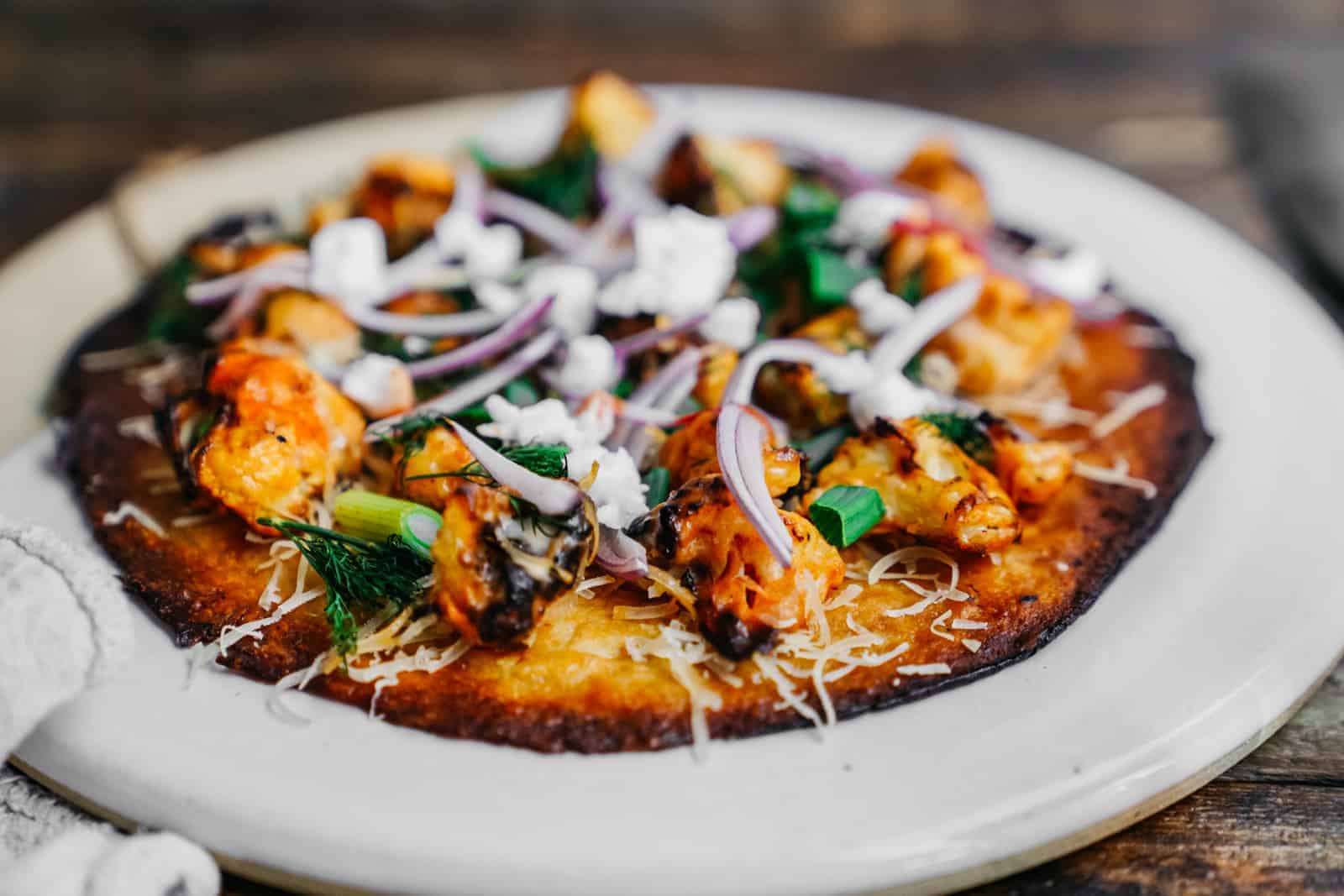 vegan cauliflower pizza crust on a plate