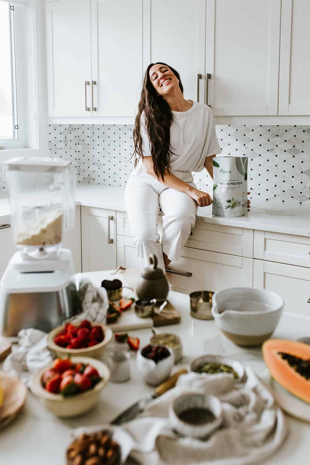 Maria on counter with protein powder bag