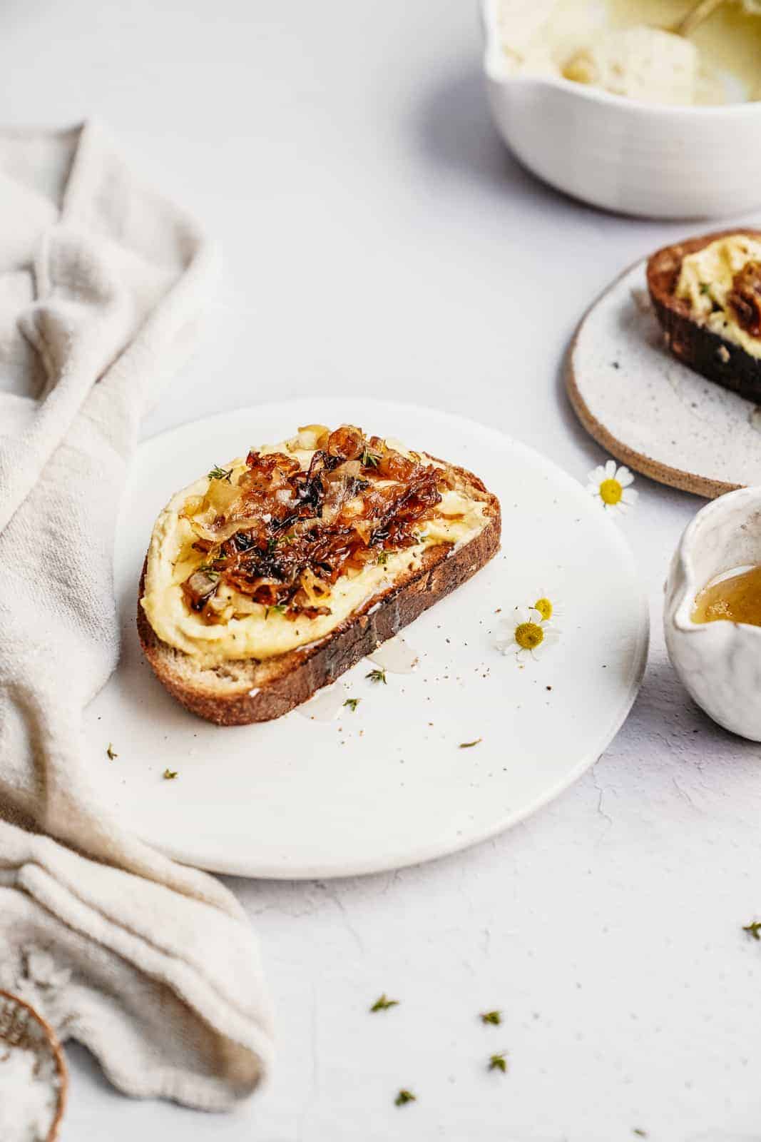 Plate with toast on it with cashew ricotta on top