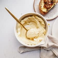 Close up of cashew ricotta in a bowl with a spoon