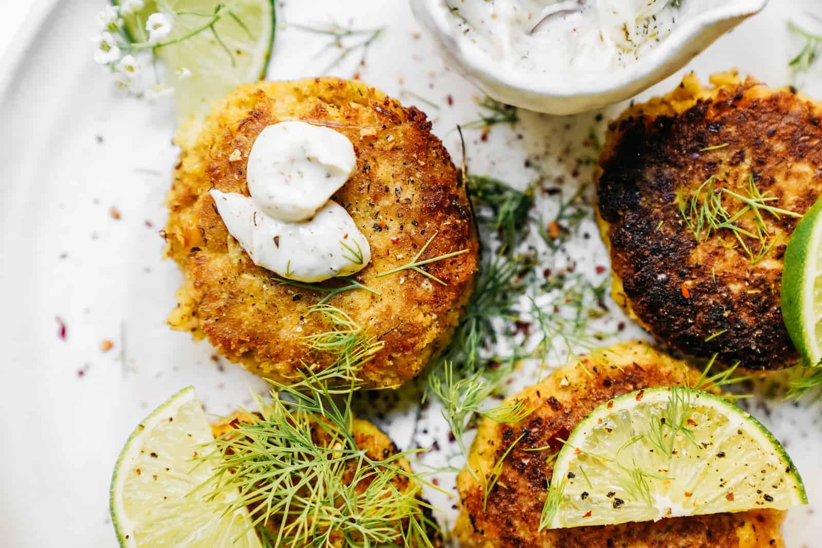 Plate of Vegan Crab Cakes and Dilly Tartar Sauce on a white plate ready to be served.