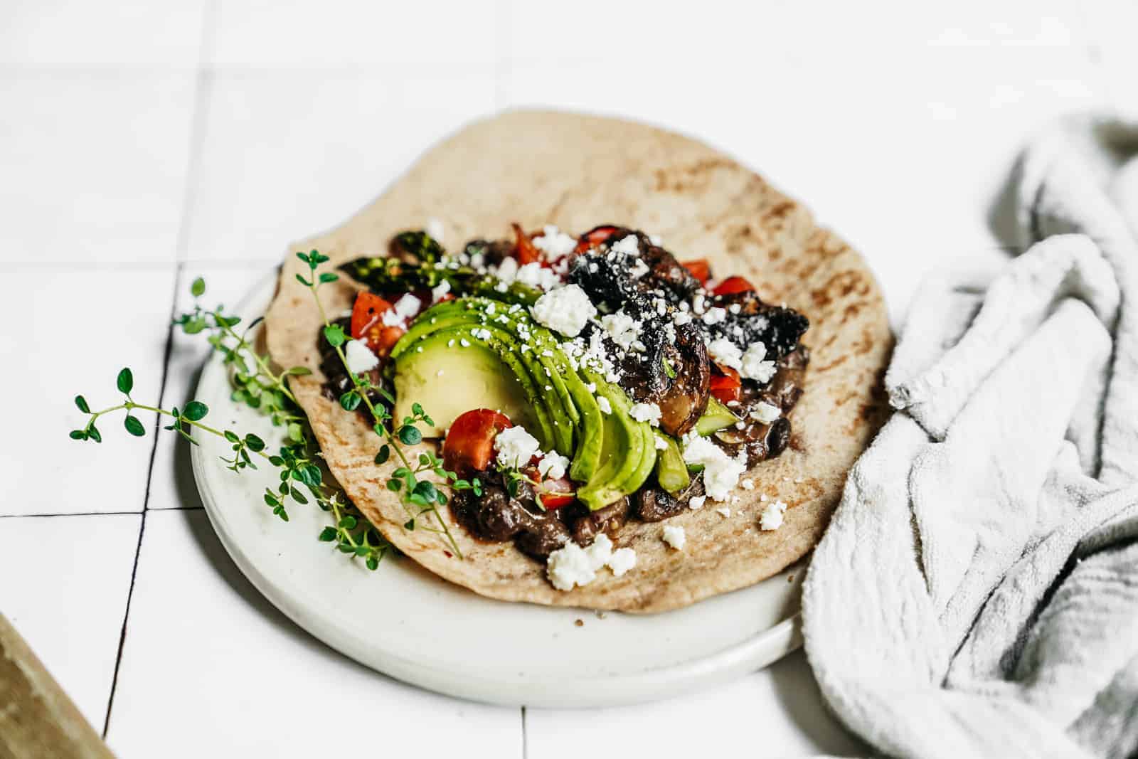 Close-up of an open face grilled vegetable wrap ready to be enjoyed.