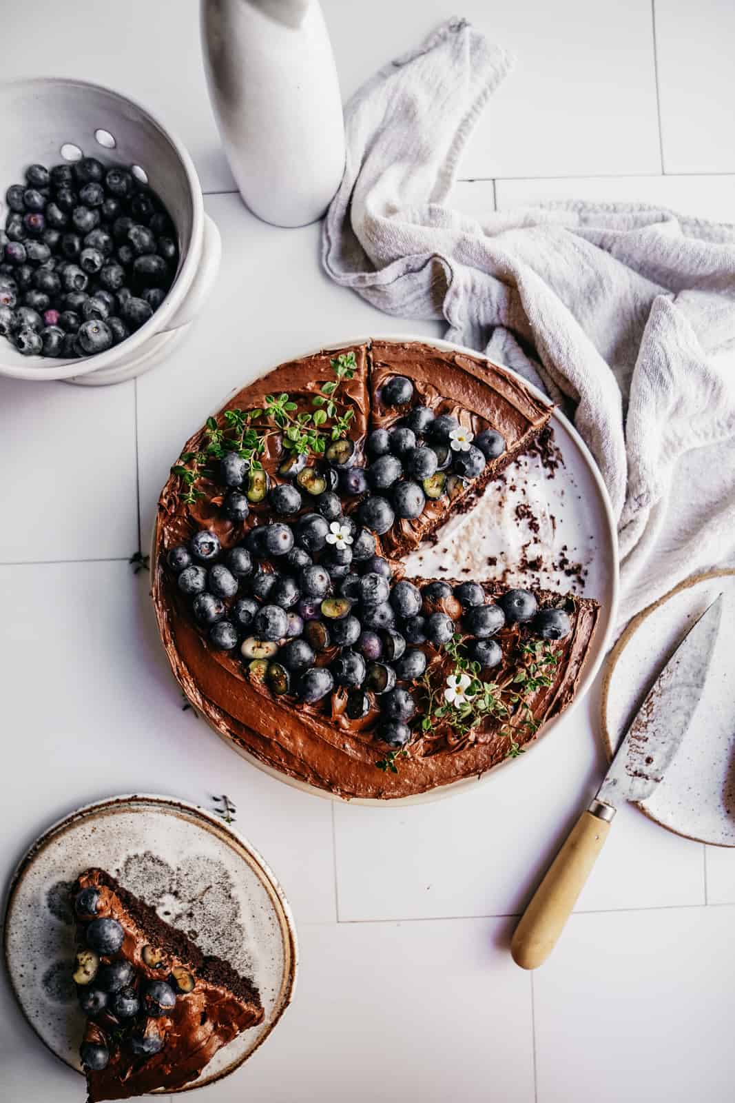 A photograph of chocolate blueberry cake that has great composition. One of Maria's food photography tricks.