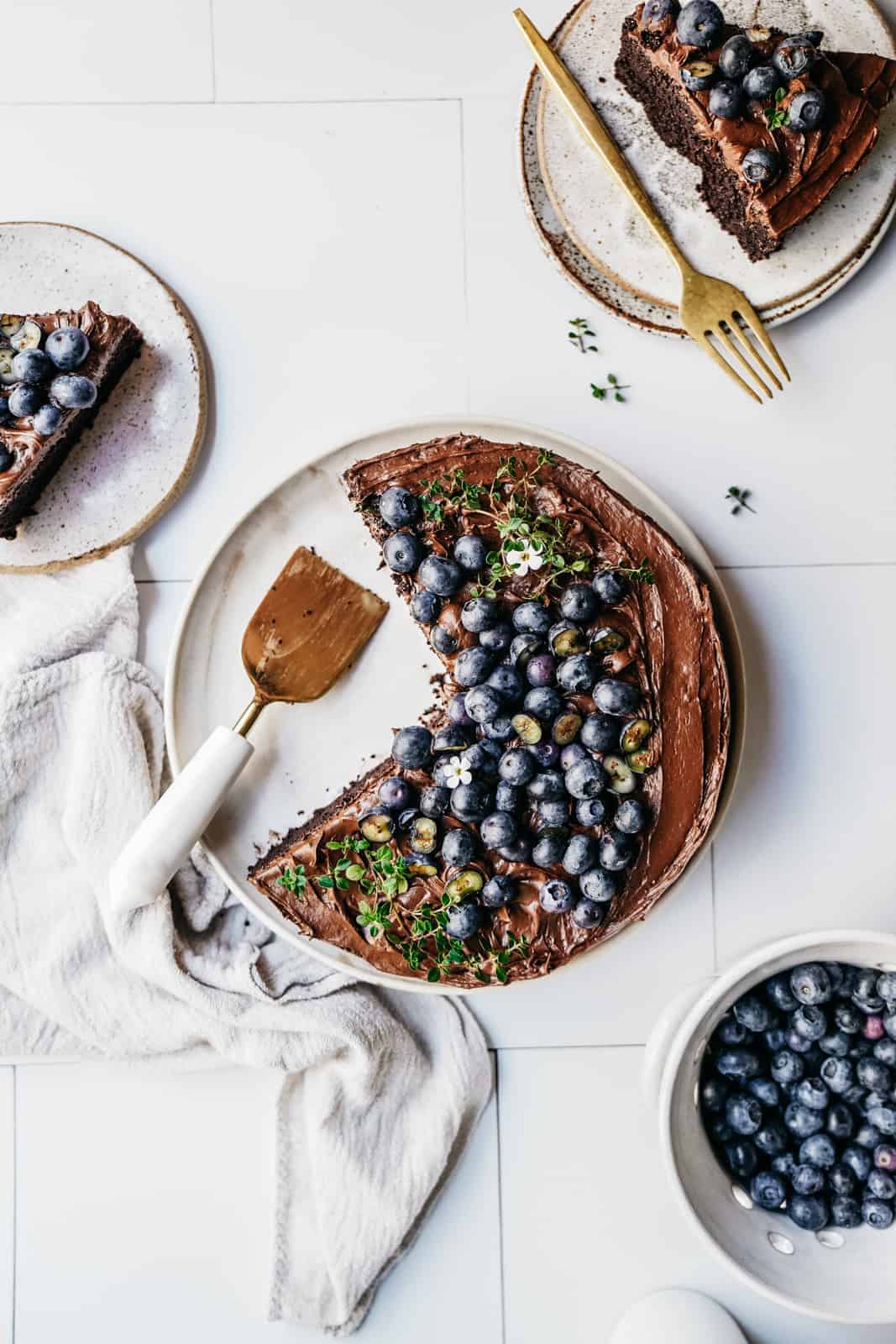 Easy Vegan Chocolate Cake with 2 slices removed and on plates with forks, ready to eat.