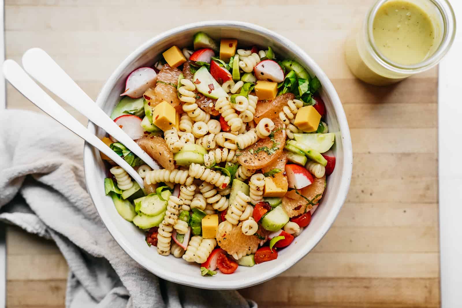 Vegetable Pasta Salad in a dish on a cutting board. A great meal prep vegan pasta recipe.