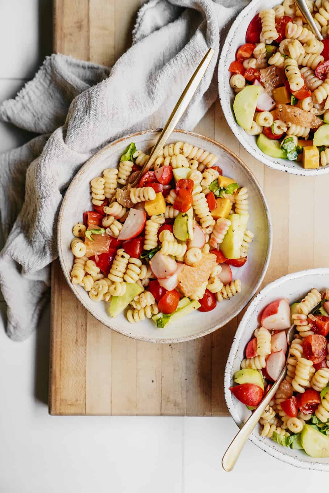 Colourful bowls of fresh pasta salad ready to be served.