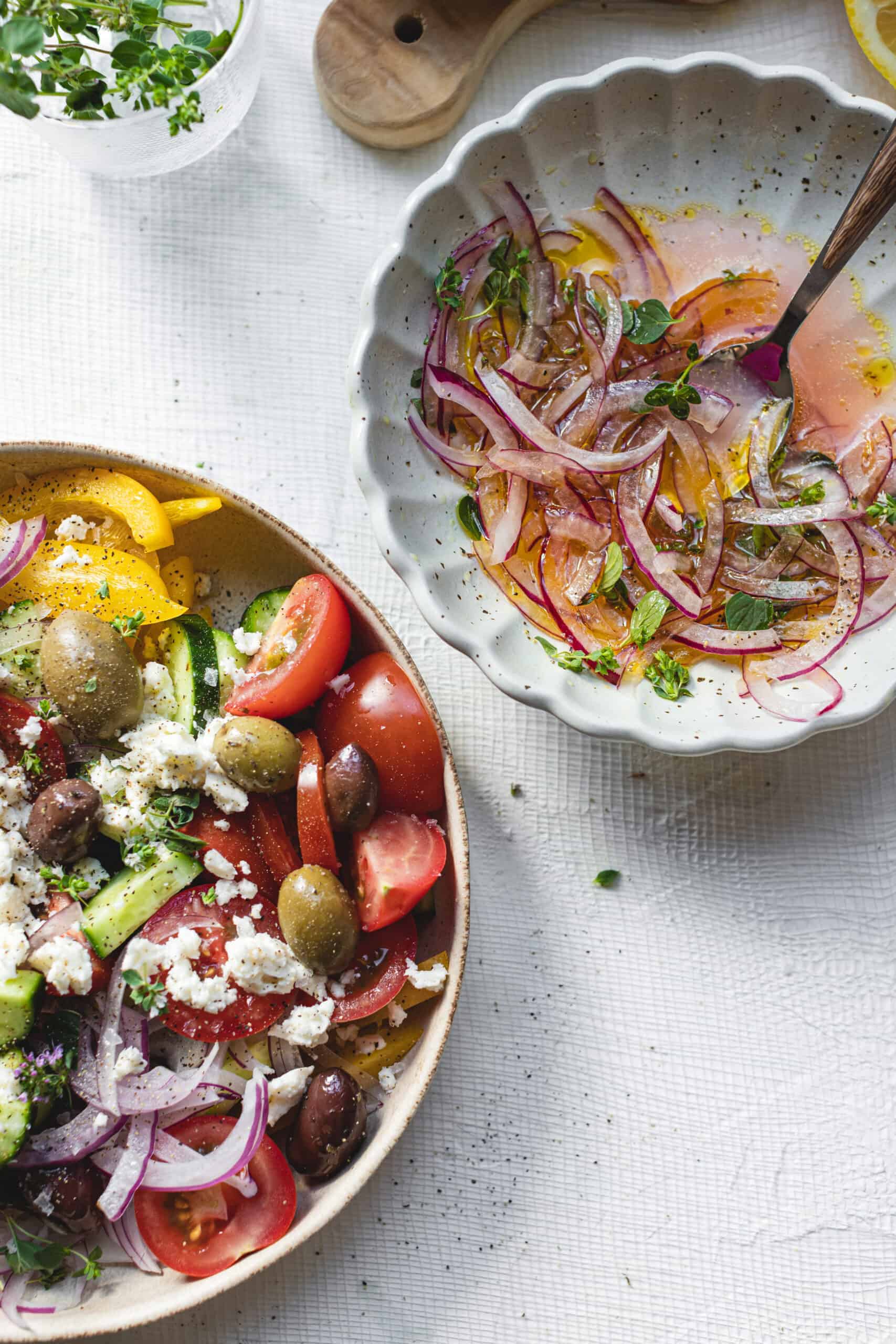 Greek Salad Recipe next to a bowl of pickled onions