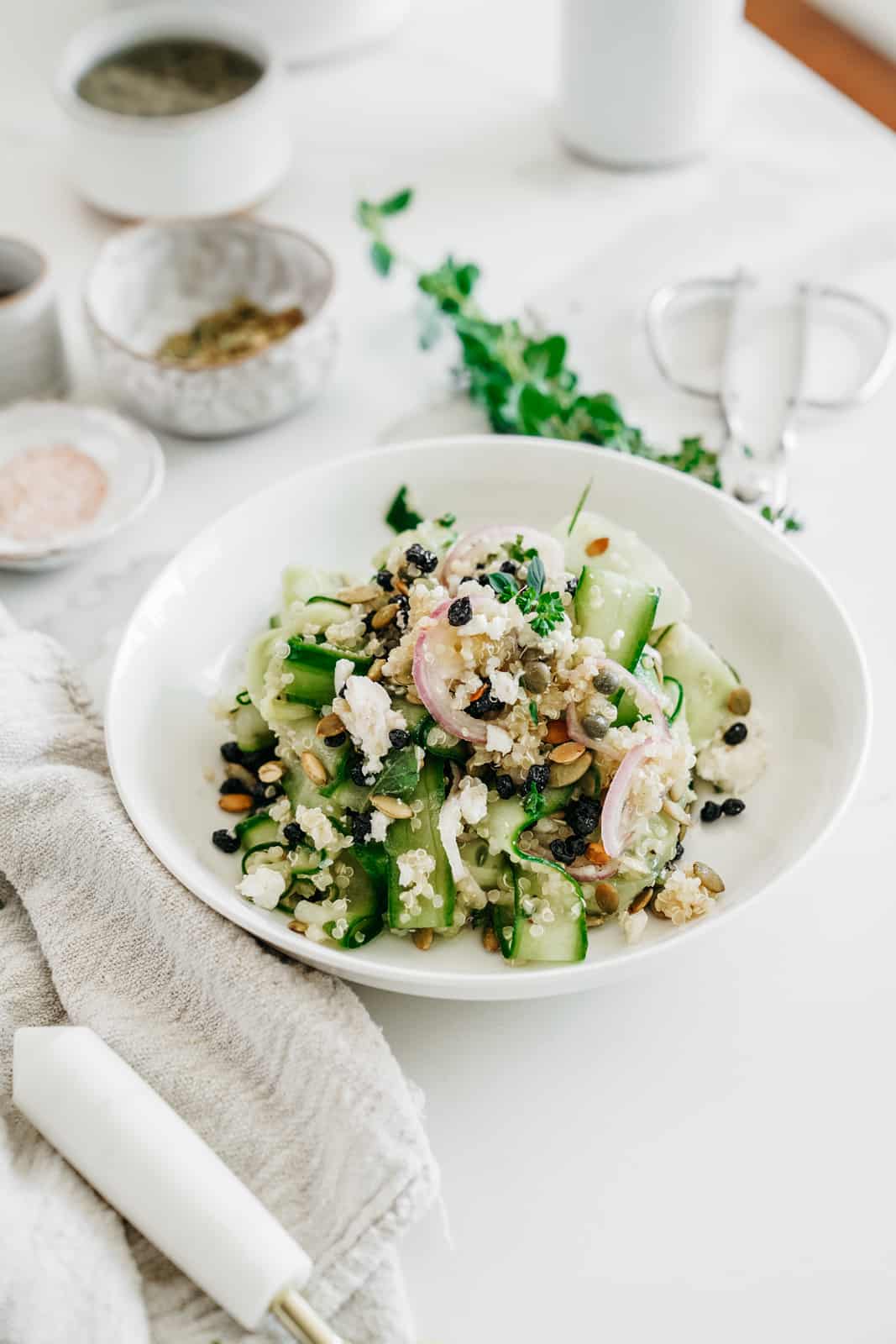 Fresh Shaved Cucumber Salad on white countertop in a serving bowl.