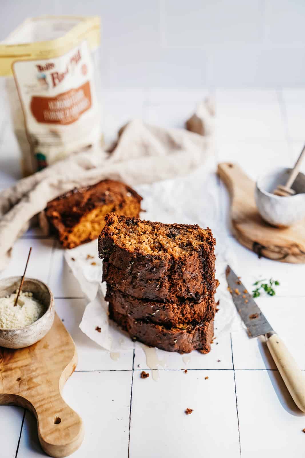 Stack of slices of Zucchini Banana Bread on a countertop.