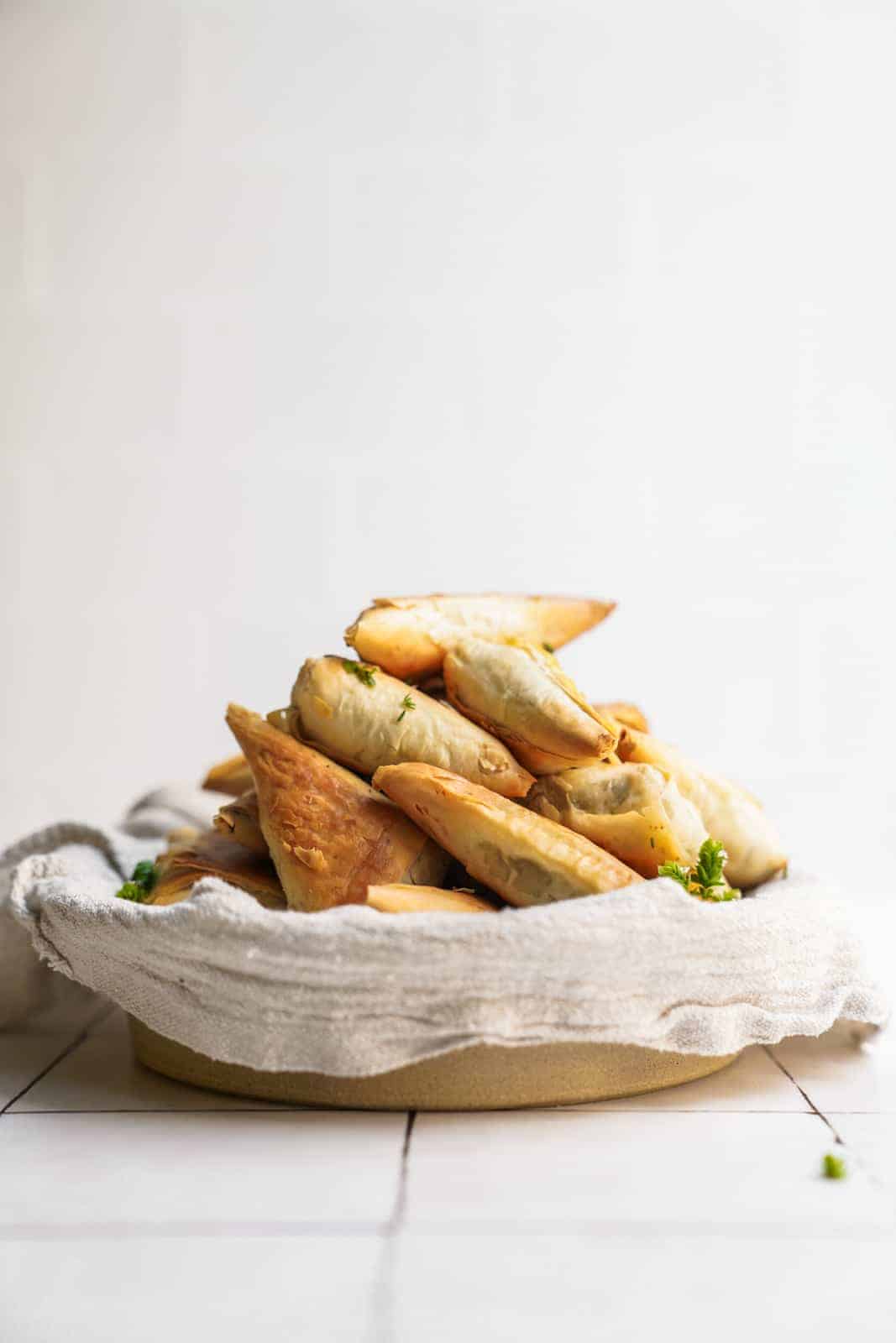 Serving dish of phyllo Creamy Mushroom Pastry bites on counter