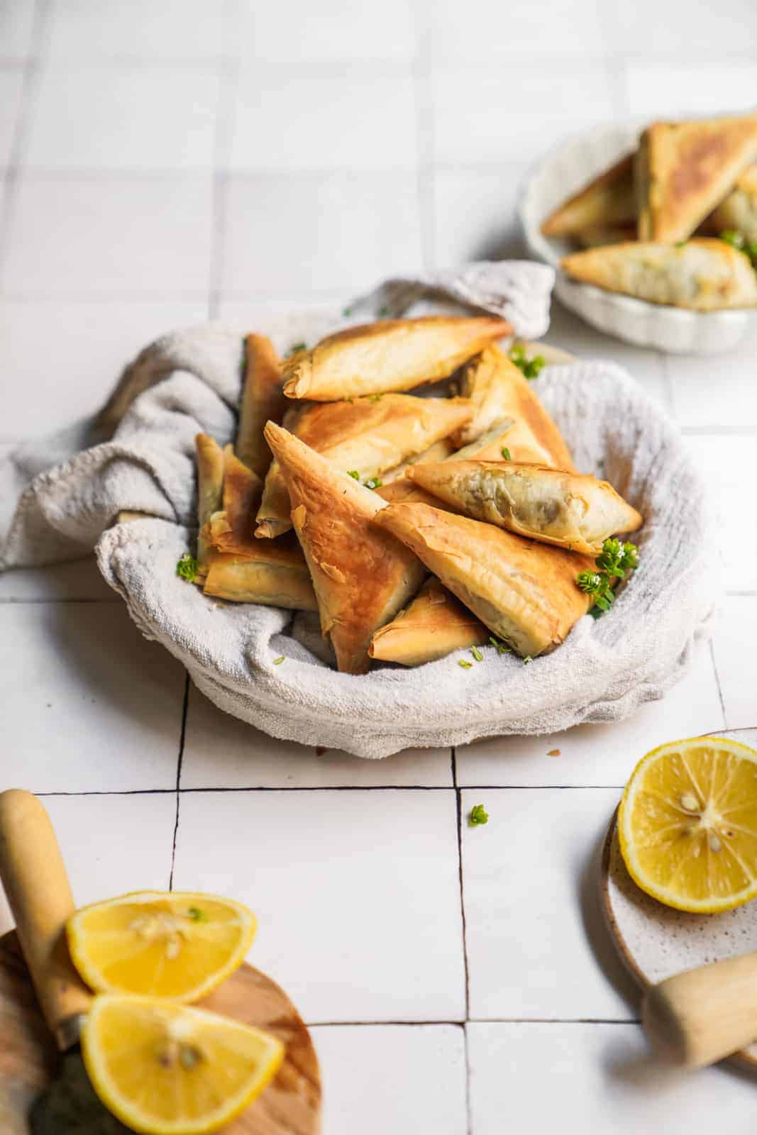 Serving dish of phyllo Creamy Mushroom Pastry bites on counter