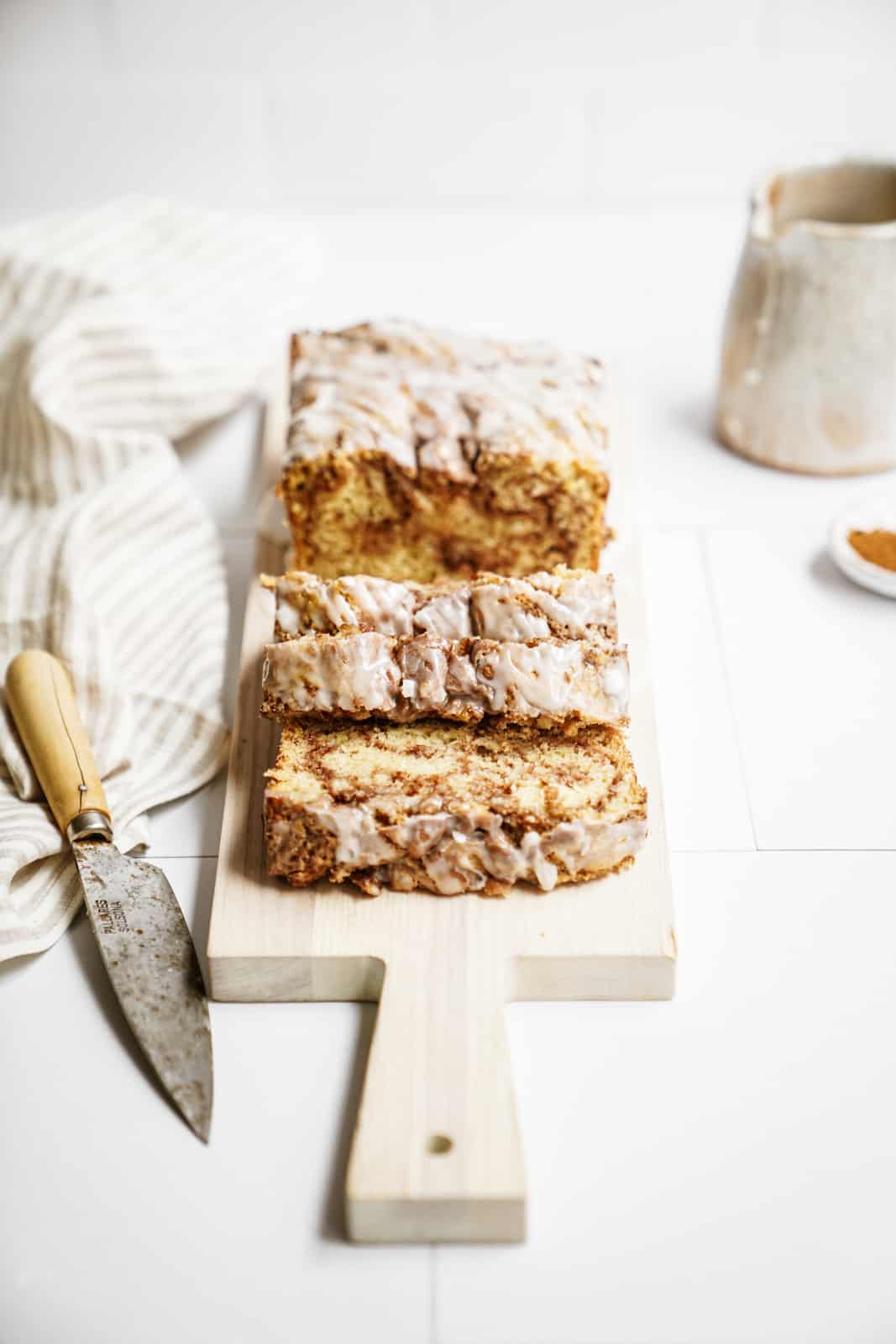 Vegan Cinnamon Bun Bread sliced on cutting board