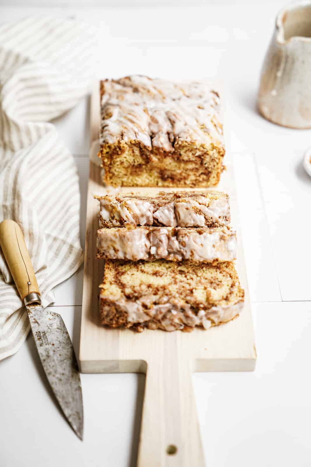 Vegan Cinnamon Bun Bread sliced on cutting board