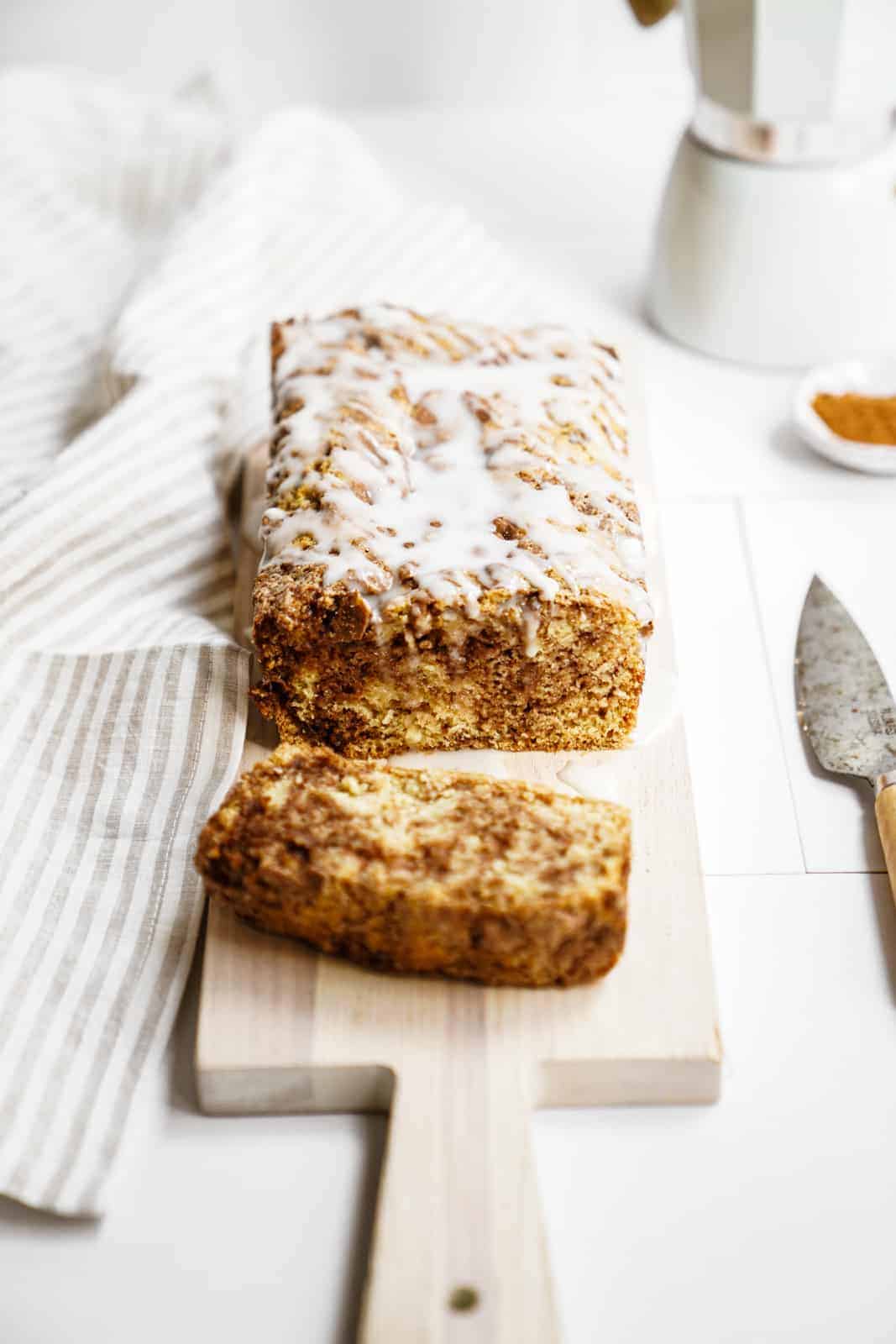 Vegan Cinnamon Bun Bread sliced on cutting board