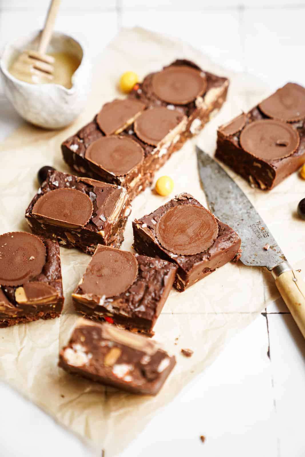 Cut up squares on counter with knife of Chocolate Peanut Butter Fudge