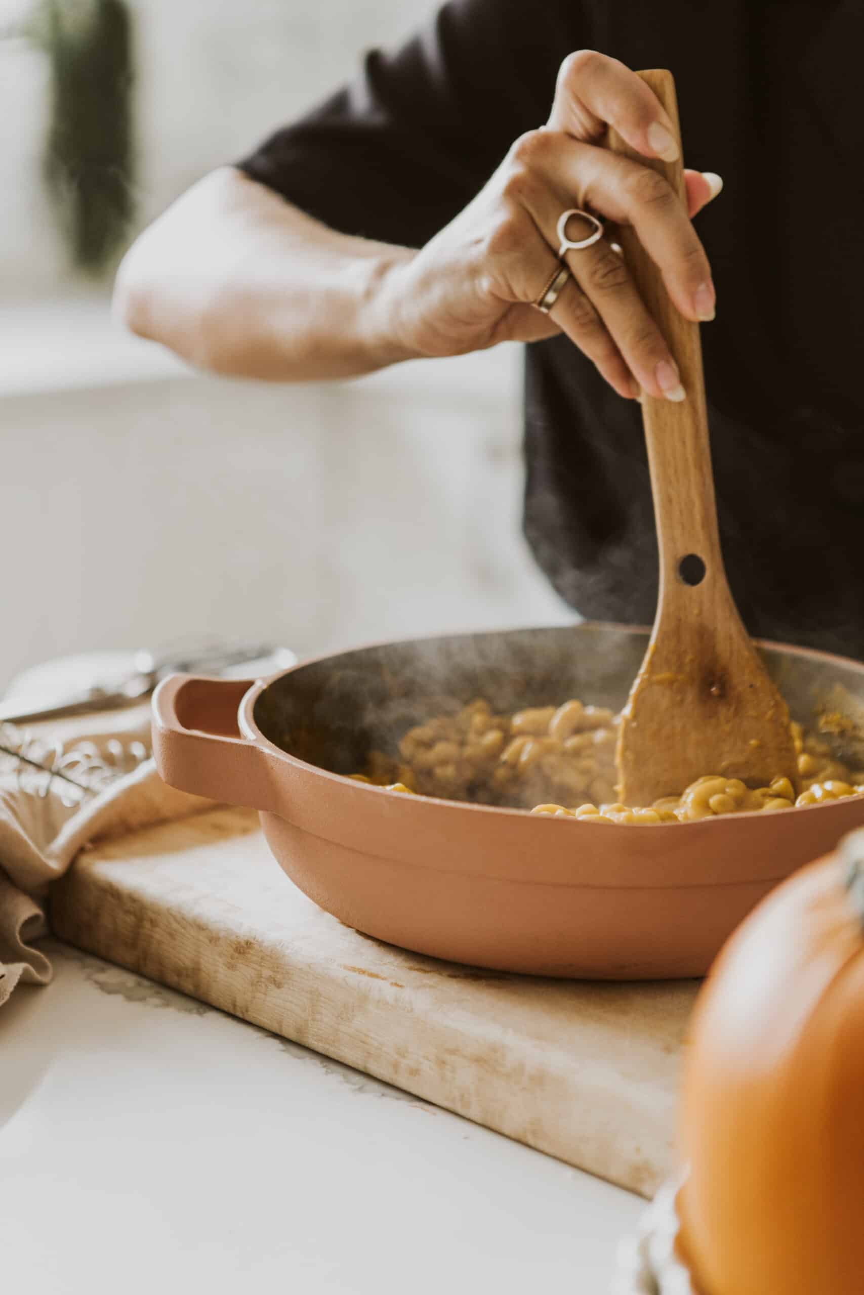 Vegan Pumpkin Mac and Cheese being stirred in a pot