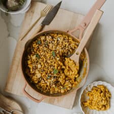 Vegan Pumpkin Mac and Cheese on cutting board in pot with spoon