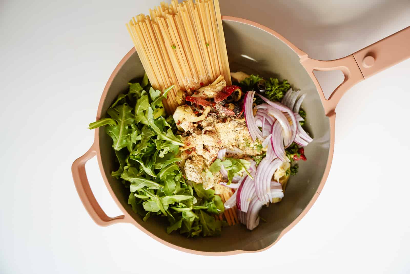 Fresh ingredients in one pot for one-pot vegetarian Greek pasta.