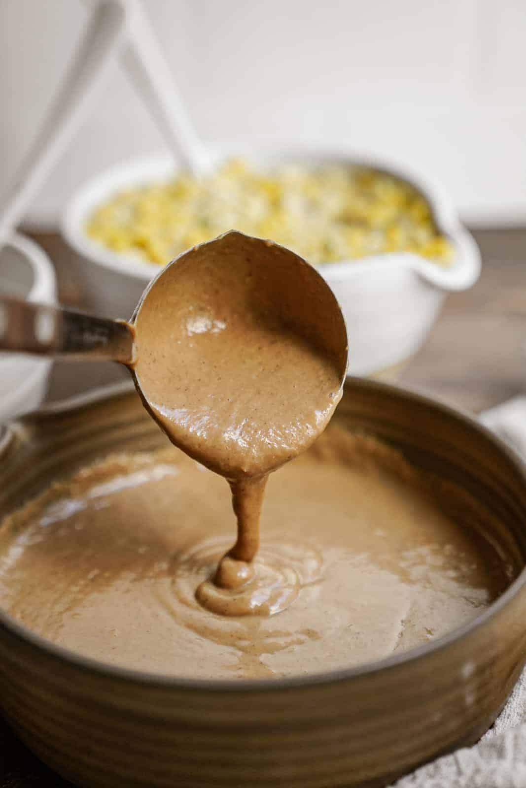 Pot of vegan gravy with ladle pouring it