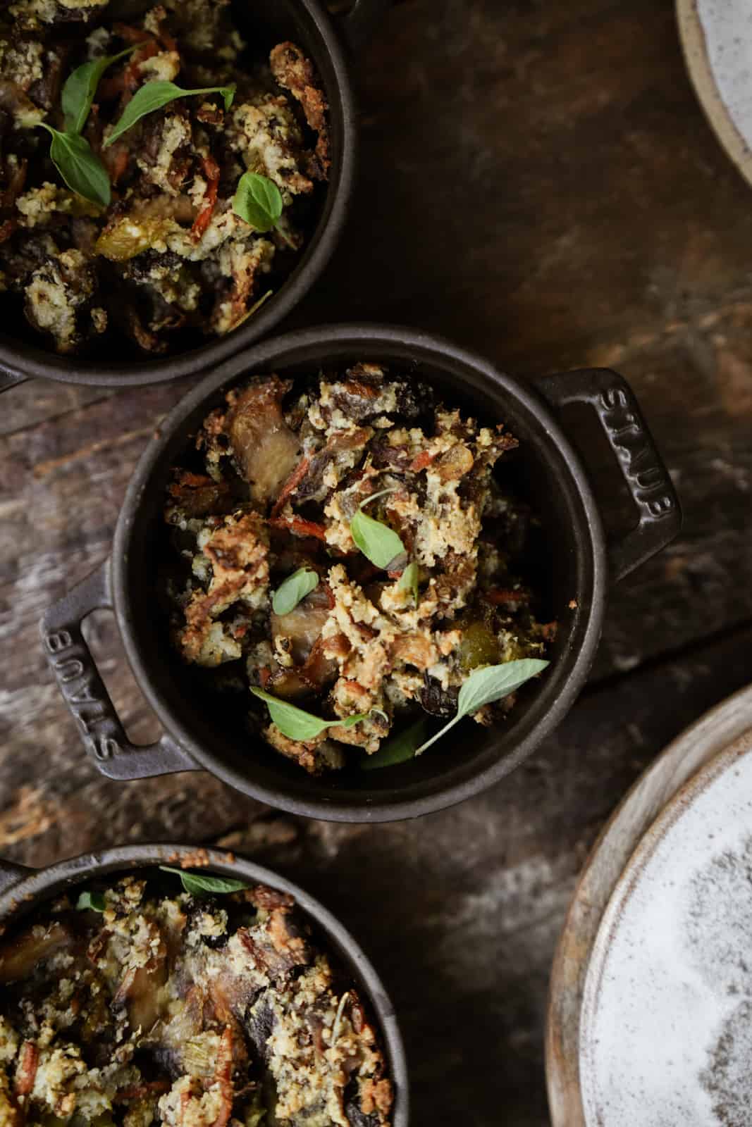 Gluten-Free Vegan Stuffing in mini pots on wooden table.