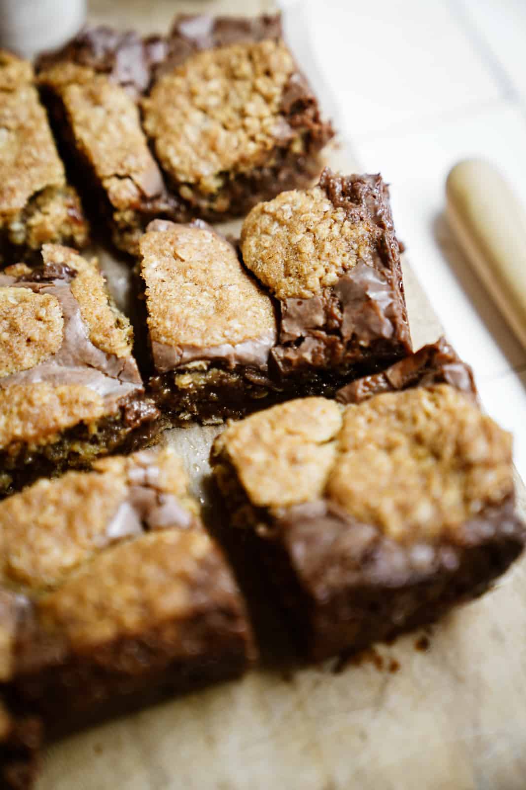 Cut Oatmeal Fudge Bars on a cutting board.