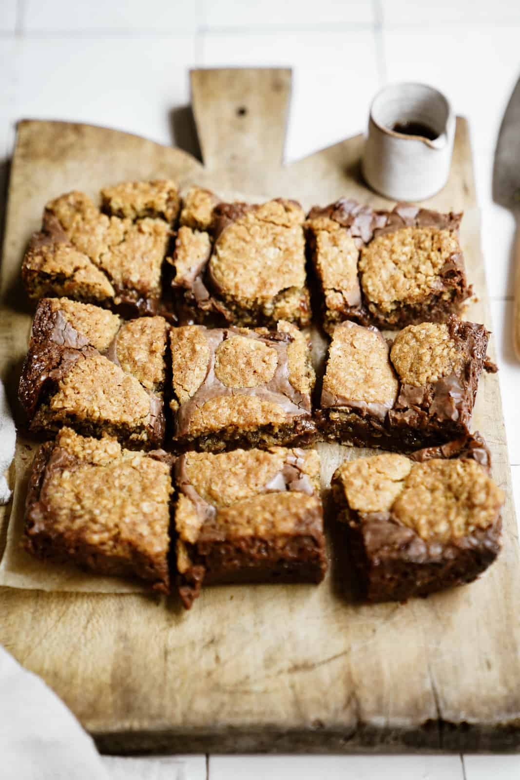 Cut Oatmeal Fudge Bars on a cutting board.