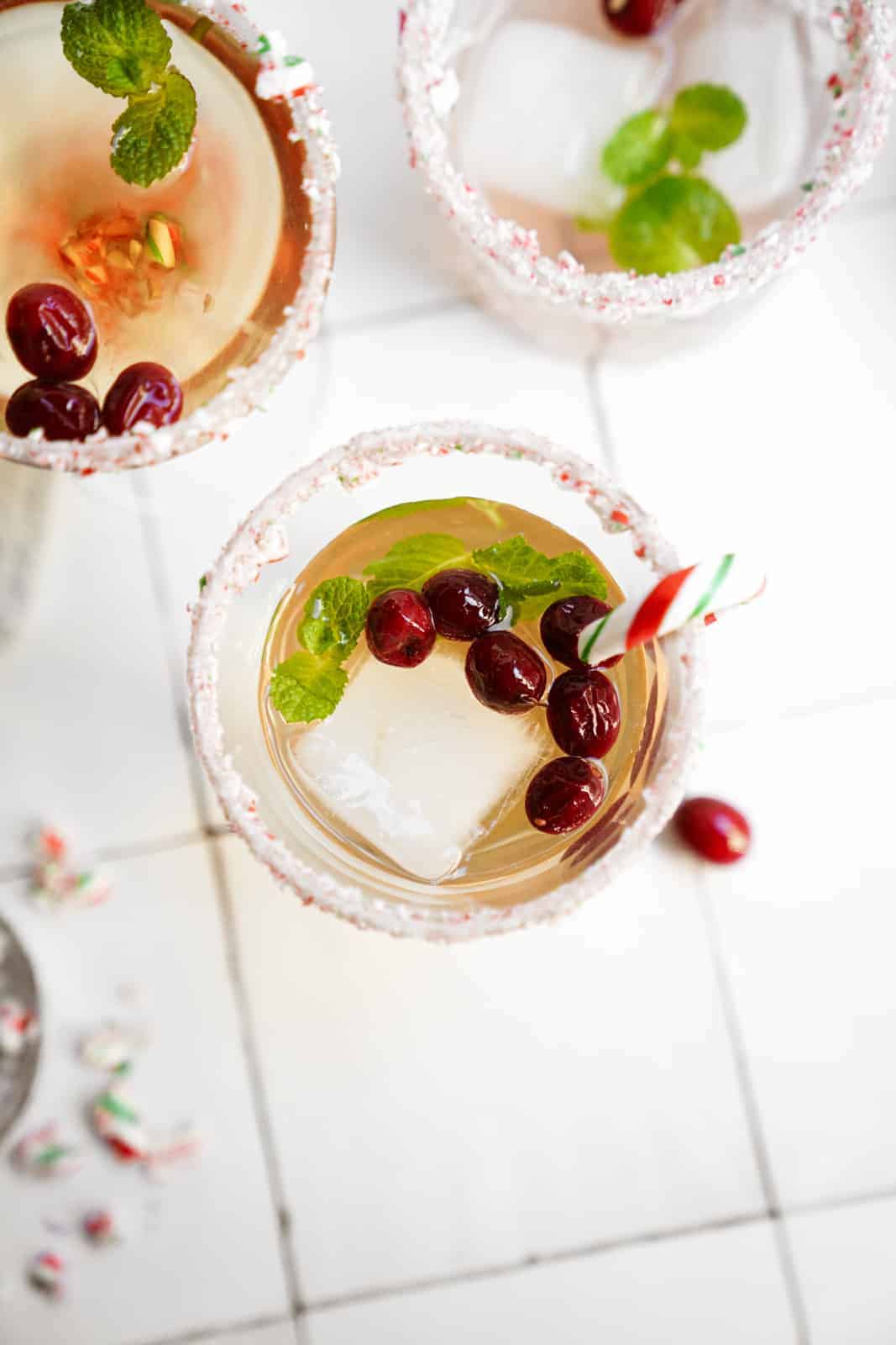 Candy cane martini in glasses on counter with a winter setting