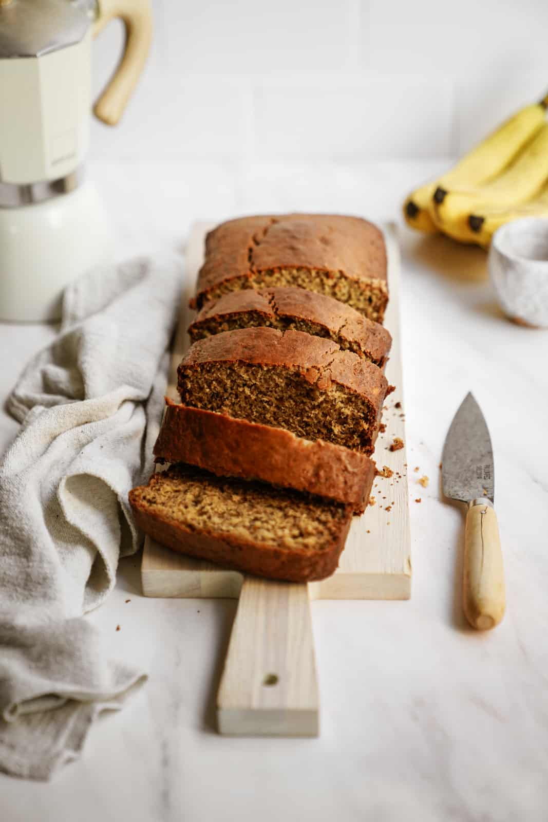 Healthy Banana Bread Recipe presented on a cutting board.