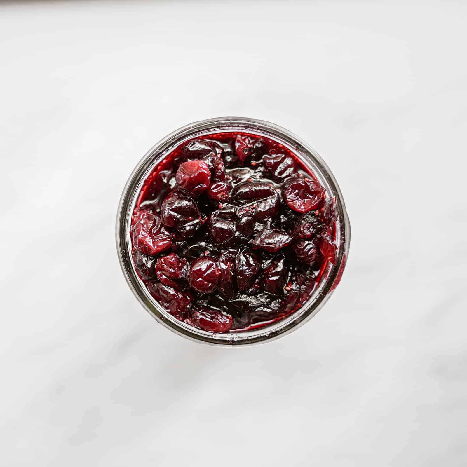 Top view of jar on counter with vegan cranberry sauce in it