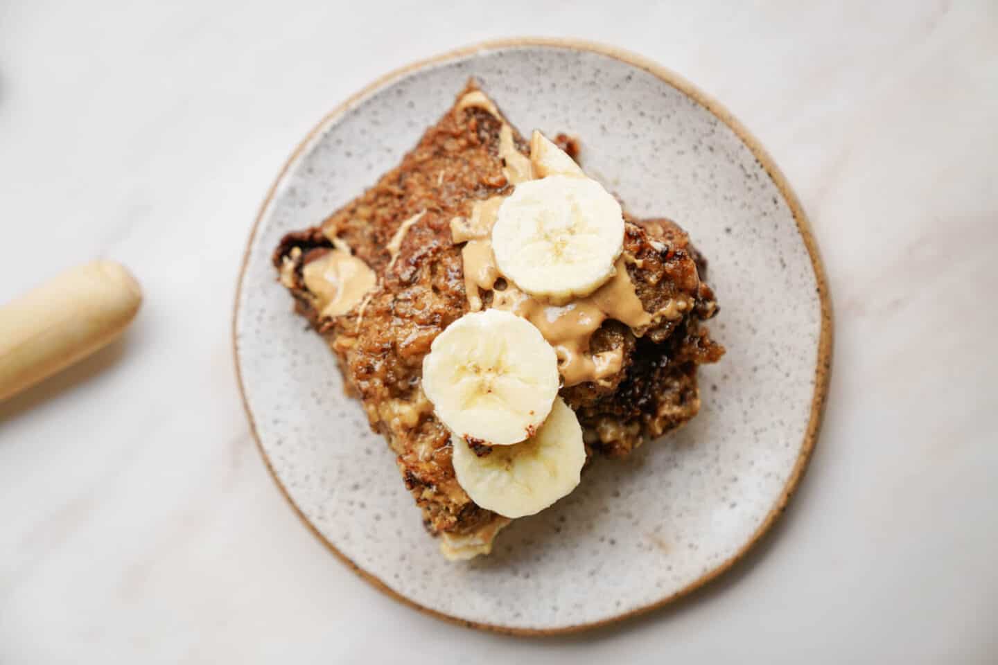 Vegan baked oatmeal with bananas cut on top.